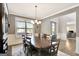 Dining room featuring hardwood floors, wainscoting, a chandelier, and natural light from the windows at 185 Discovery Lake Dr, Fayetteville, GA 30215