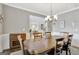 Spacious dining room with hardwood floors, wainscoting and open layout to other living spaces at 185 Discovery Lake Dr, Fayetteville, GA 30215