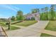Long driveway leading to a beautiful home with well-maintained landscaping at 185 Discovery Lake Dr, Fayetteville, GA 30215