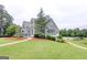 This view of the property displays its beautiful landscaping, pool and meticulous grounds at 185 Discovery Lake Dr, Fayetteville, GA 30215