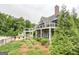 Exterior view of building with manicured lawn and landscaping, featuring a deck at 185 Discovery Lake Dr, Fayetteville, GA 30215