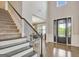 A bright and inviting foyer with staircase, hardwood floors, and a view into the dining room at 185 Discovery Lake Dr, Fayetteville, GA 30215
