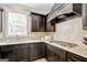 A kitchen with stainless appliances, dark cabinets, and granite countertops at 185 Discovery Lake Dr, Fayetteville, GA 30215
