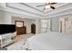 The main bedroom has carpeted floors, a tray ceiling with a ceiling fan, and multiple furnishings at 185 Discovery Lake Dr, Fayetteville, GA 30215