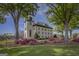 Classic town building surrounded by manicured lawns, flowering bushes, and mature trees at 185 Discovery Lake Dr, Fayetteville, GA 30215