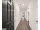 Inviting hallway featuring wood-look flooring and neutral walls providing a seamless transition between spaces at 1624 Palladian Way # 117, Lithonia, GA 30058