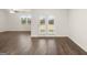 Bright living room featuring hardwood floors, a ceiling fan, and glass doors to a backyard at 1624 Palladian Way # 117, Lithonia, GA 30058