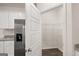 Walk-in pantry with wire shelving for efficient storage, complemented by modern stainless steel refrigerator at 1624 Palladian Way # 117, Lithonia, GA 30058