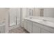 Stylish bathroom showcasing dual sinks, marble counters, a shower, and a soaking tub at 1626 Palladian Way # 118, Lithonia, GA 30058