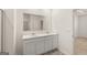 Bright bathroom featuring dual sinks, marble counters, and white cabinets at 1626 Palladian Way # 118, Lithonia, GA 30058