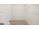 Walk-in closet with wire shelving, carpeted floor, white trim, and door at 1626 Palladian Way # 118, Lithonia, GA 30058