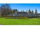 Landscaped entrance to Champions Run featuring a stone sign, vibrant flower beds, and a well-manicured lawn at 1626 Palladian Way # 118, Lithonia, GA 30058