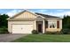 Charming one-story home showcasing a two-car garage and a beautifully landscaped front yard at 1626 Palladian Way # 118, Lithonia, GA 30058