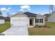 Charming one-story home with a two-car garage, stone accents, and manicured lawn at 1626 Palladian Way # 118, Lithonia, GA 30058