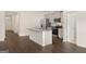 Bright kitchen with an island, granite countertops, stainless steel appliances, and wood floors throughout at 1626 Palladian Way # 118, Lithonia, GA 30058