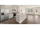 Modern kitchen with stainless steel appliances, granite countertops, and an island overlooking an open floor plan at 1626 Palladian Way # 118, Lithonia, GA 30058