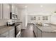 A view of the kitchen featuring stainless steel appliances, granite countertops, and modern finishes at 1626 Palladian Way # 118, Lithonia, GA 30058