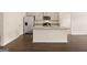 Open kitchen featuring an island with granite countertops, stainless appliances, and wood flooring at 1626 Palladian Way # 118, Lithonia, GA 30058