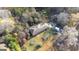 A single-story home with a large yard and mature trees, as seen from an aerial perspective at 98 Almon Church Rd, Covington, GA 30014