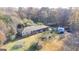 Aerial view of the home with large yard, mature trees, and driveway at 98 Almon Church Rd, Covington, GA 30014