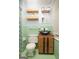 Stylish bathroom with wood cabinets, a vessel sink, floating shelves, and green tile walls at 98 Almon Church Rd, Covington, GA 30014