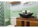 Unique bathroom featuring green tile, a vessel sink, and modern fixtures at 98 Almon Church Rd, Covington, GA 30014