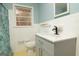 Bright bathroom featuring a gray vanity with a modern black faucet and a window for natural light at 98 Almon Church Rd, Covington, GA 30014