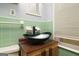 Bathroom showcases a unique black vessel sink and bright tile walls at 98 Almon Church Rd, Covington, GA 30014