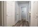 Hallway with fresh paint and wood-look flooring, leading to multiple bedrooms at 98 Almon Church Rd, Covington, GA 30014
