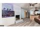 Open-concept living room with a brick fireplace, wood-look floors, and access to the kitchen at 98 Almon Church Rd, Covington, GA 30014
