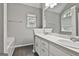 Bathroom featuring double sinks, large mirrors and a tub at 28 Willow Ridge Dr, Hampton, GA 30228