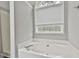 Soaking tub in a bathroom with a garden window at 28 Willow Ridge Dr, Hampton, GA 30228