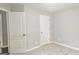 Cozy bedroom features plush carpeting and two doors at 28 Willow Ridge Dr, Hampton, GA 30228