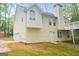 Rear exterior view of a two-story home featuring light siding, a deck, and attached garage at 28 Willow Ridge Dr, Hampton, GA 30228