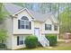 Inviting home featuring light siding, black shutter accents, neat landscaping, and a cozy shed in its backyard at 28 Willow Ridge Dr, Hampton, GA 30228