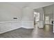 Open-concept living area featuring wainscoting, hard surface floors, and ample natural light at 28 Willow Ridge Dr, Hampton, GA 30228