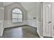Living area with a vaulted ceiling, a large window, and classic white trim at 28 Willow Ridge Dr, Hampton, GA 30228