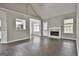 Spacious open living space with a fireplace, hard surface floors, and modern lighting at 28 Willow Ridge Dr, Hampton, GA 30228