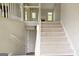 Open staircase featuring carpeted steps, white railings, and access to the basement at 28 Willow Ridge Dr, Hampton, GA 30228