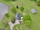 An aerial view of a stately home on lush acreage, featuring a pond, barn, and mature trees at 39 Gabrielle Ct, Stockbridge, GA 30281