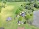 A sprawling property with a brick home, barn, guest house, gardens and lake, captured in an aerial view at 39 Gabrielle Ct, Stockbridge, GA 30281