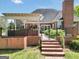 Backyard patio and pergola, landscaped fence, brick wall and steps to backyard living space at 39 Gabrielle Ct, Stockbridge, GA 30281
