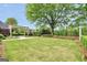 Spacious backyard with a pavilion, outdoor kitchen, manicured lawn, and mature trees at 39 Gabrielle Ct, Stockbridge, GA 30281