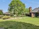 Tranquil backyard featuring a gazebo, patio, and lush landscaping adjacent to a stately brick home at 39 Gabrielle Ct, Stockbridge, GA 30281