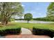 Picturesque backyard view featuring a tranquil lake and lush greenery with manicured hedges at 39 Gabrielle Ct, Stockbridge, GA 30281