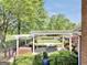 Backyard featuring an outdoor patio with dining set, brick grill, and fenced lawn with mature trees at 39 Gabrielle Ct, Stockbridge, GA 30281