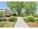 Lush backyard featuring an outdoor kitchen, pavilion, manicured bushes, and mature tree at 39 Gabrielle Ct, Stockbridge, GA 30281