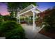 Backyard patio area featuring an outdoor grill, dining space, and overhead pergola with string lights at 39 Gabrielle Ct, Stockbridge, GA 30281