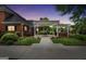 Dusk view of a cozy backyard with a covered patio and lush landscaping at 39 Gabrielle Ct, Stockbridge, GA 30281
