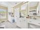 Spacious bathroom with white cabinets, double sinks, and tile flooring at 39 Gabrielle Ct, Stockbridge, GA 30281